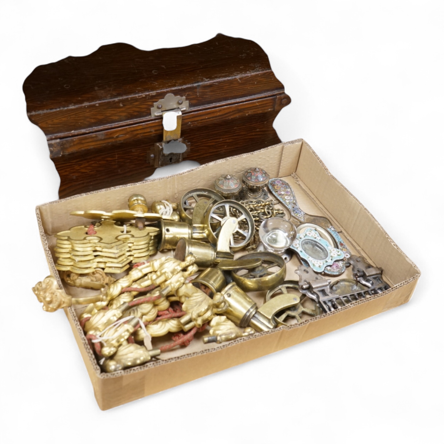 A brush grained tin trunk containing brass furniture mounts and fittings and a micromosaic miniature photo frame and hand mirror, trunk 47cm wide (a.f.)